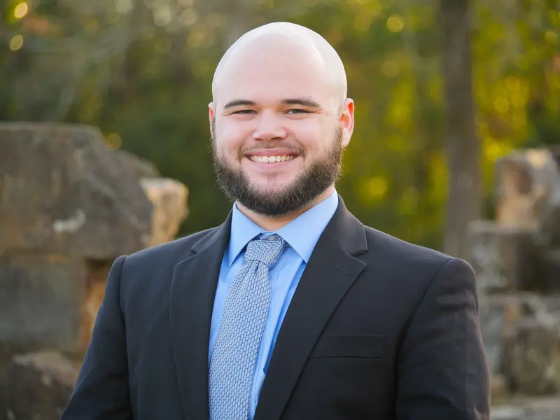 Outdoor corporate headshot of a man in a suit