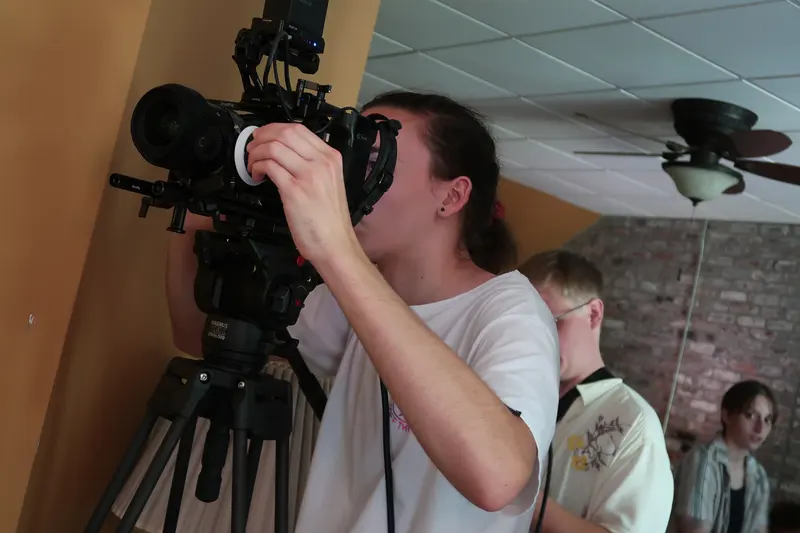 Camera operator with a shoulder-rigged cinema camera