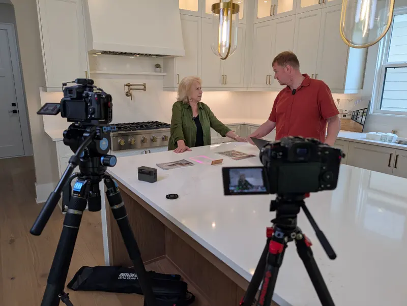 Two-camera kitchen shoot with two people talking at a counter
